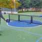 Two guys playing pickleball on a basketball court