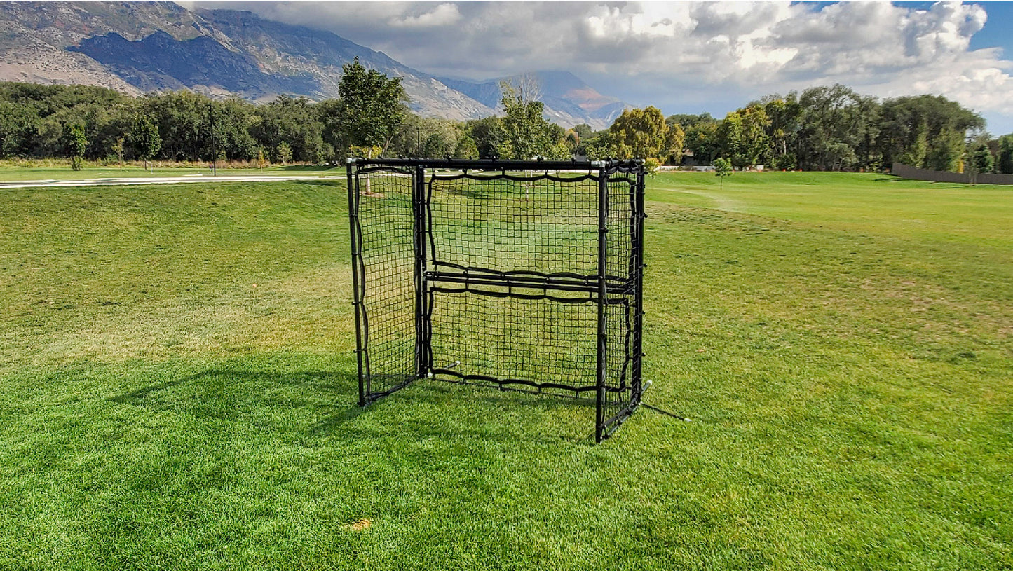 Panna soccer cage frame on a field surrounded by trees
