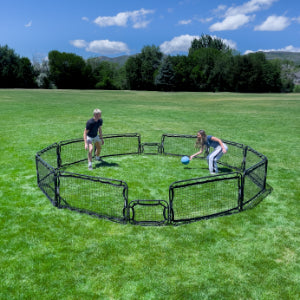 Two people playing gaga ball with Infinets in a field