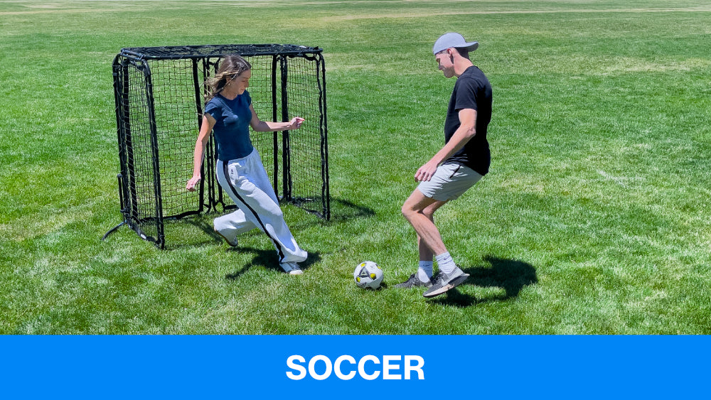 two people playing soccer in front of a portable soccer net.