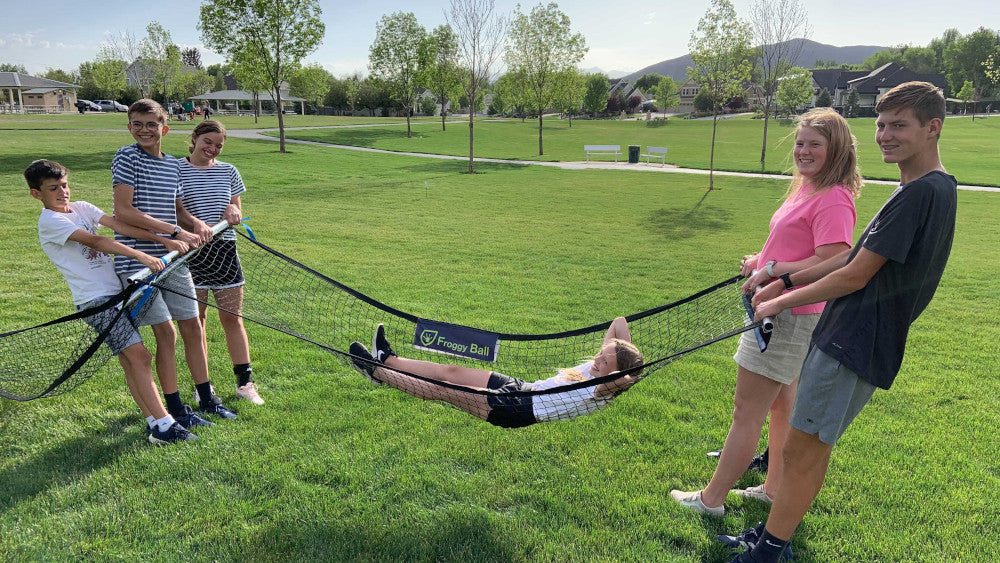 Kids using Gaga Ball net as a hammock